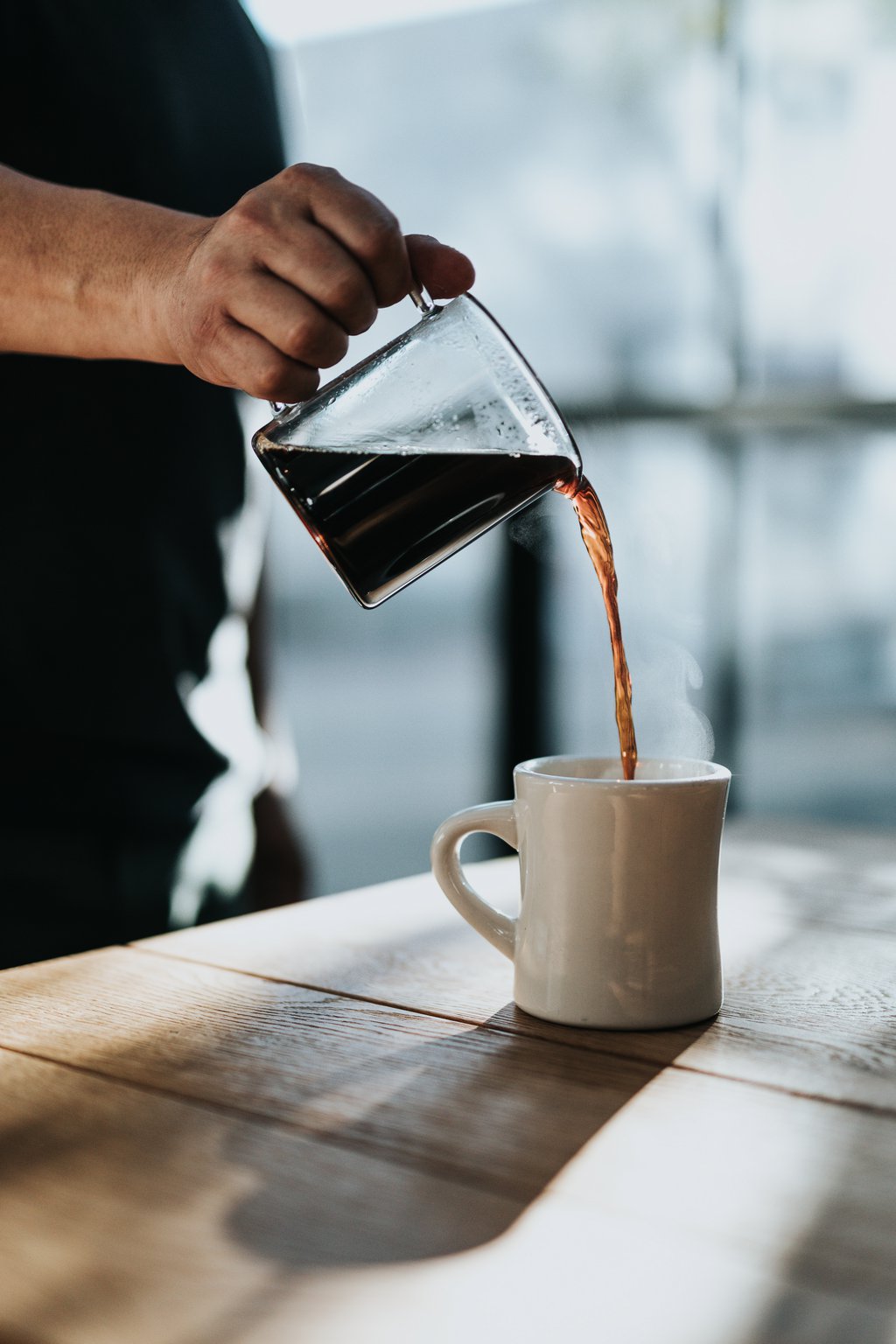 Jug of coffee being poured into a mug